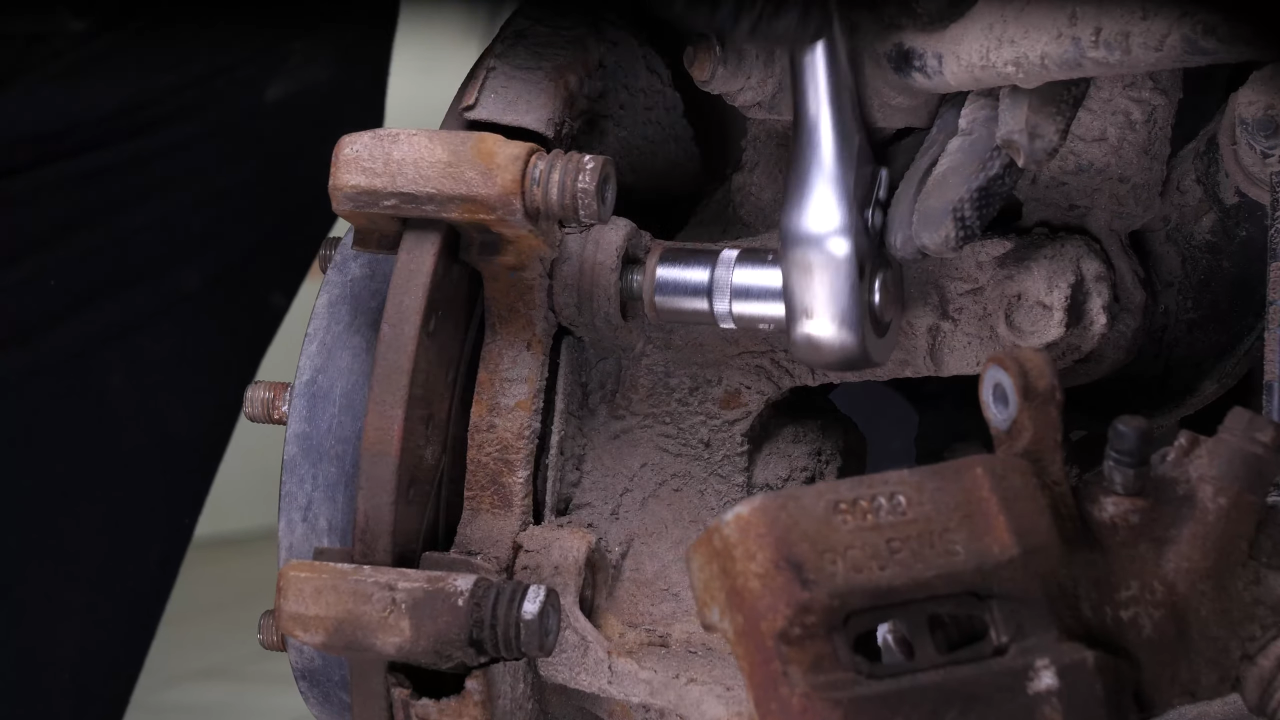 Remove the  brake caliper mount