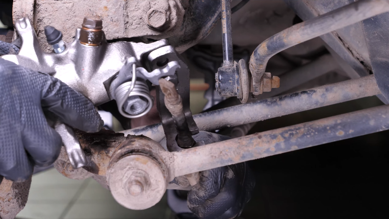 Put the parking brake cable back