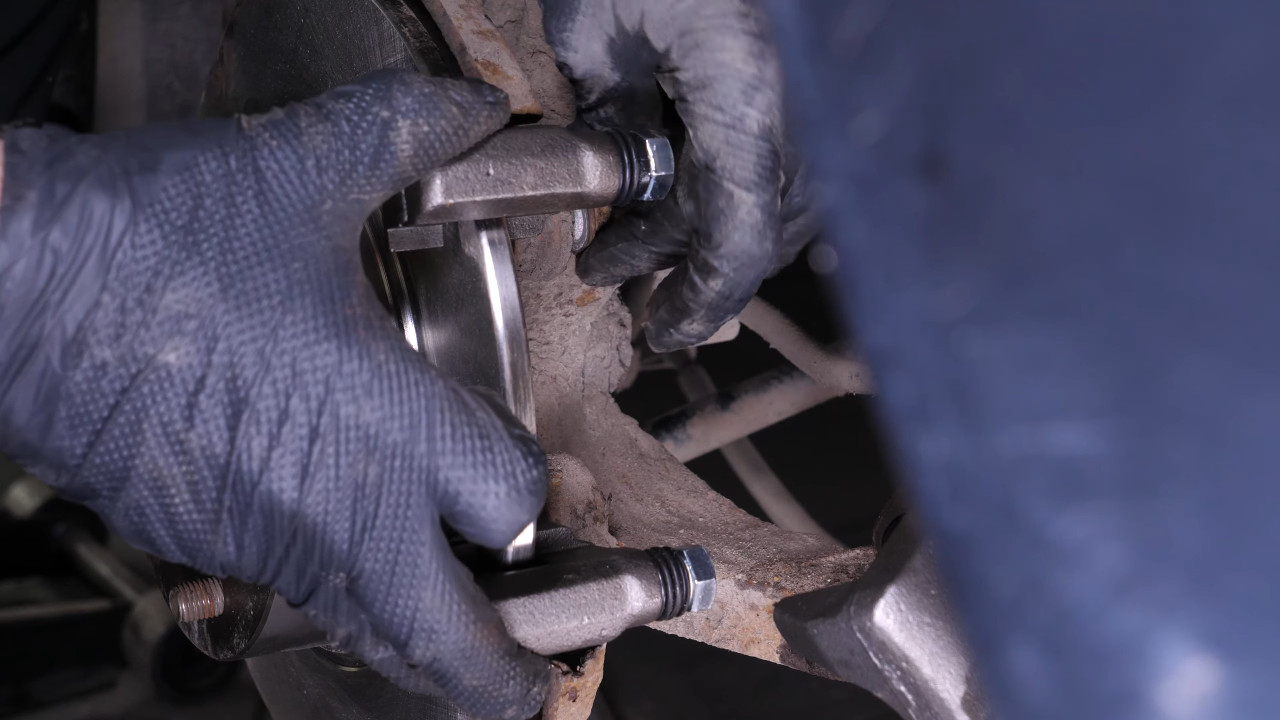 Put the brake caliper mount back on