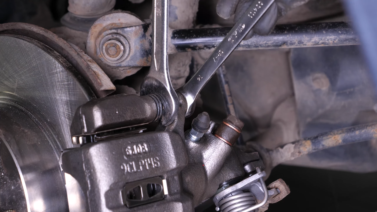 Put the brake caliper back