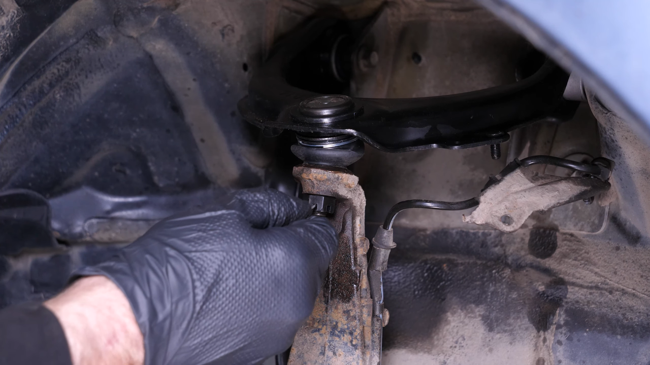 Put the control arm ball joint back