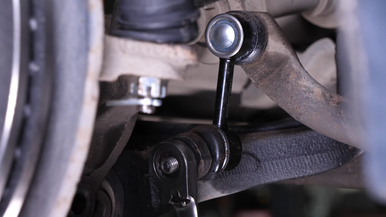 Disengage the sway bar end link