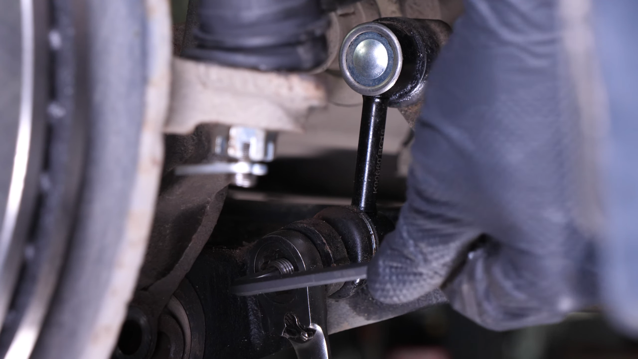Disengage the sway bar end link