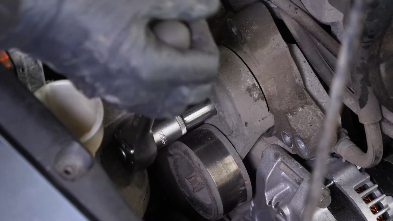 Remove the serpentine belt tensioner 
