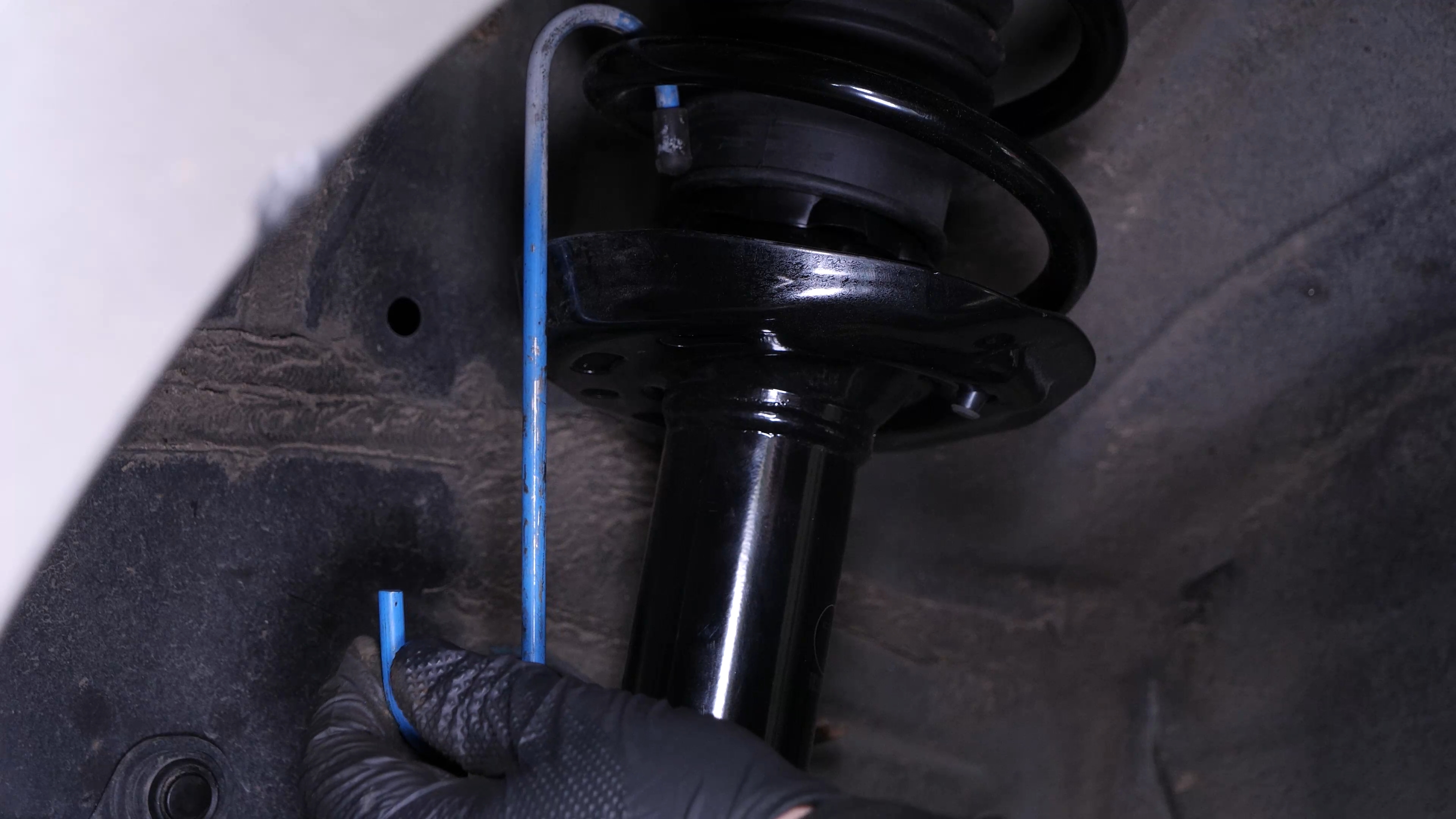 Hang the brake caliper on the strut