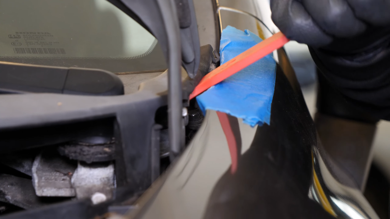 Remove the bolts along the hood
