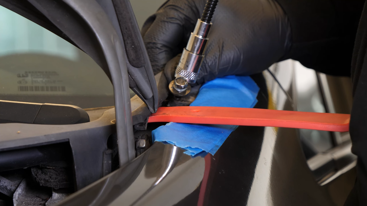 Remove the bolts along the hood