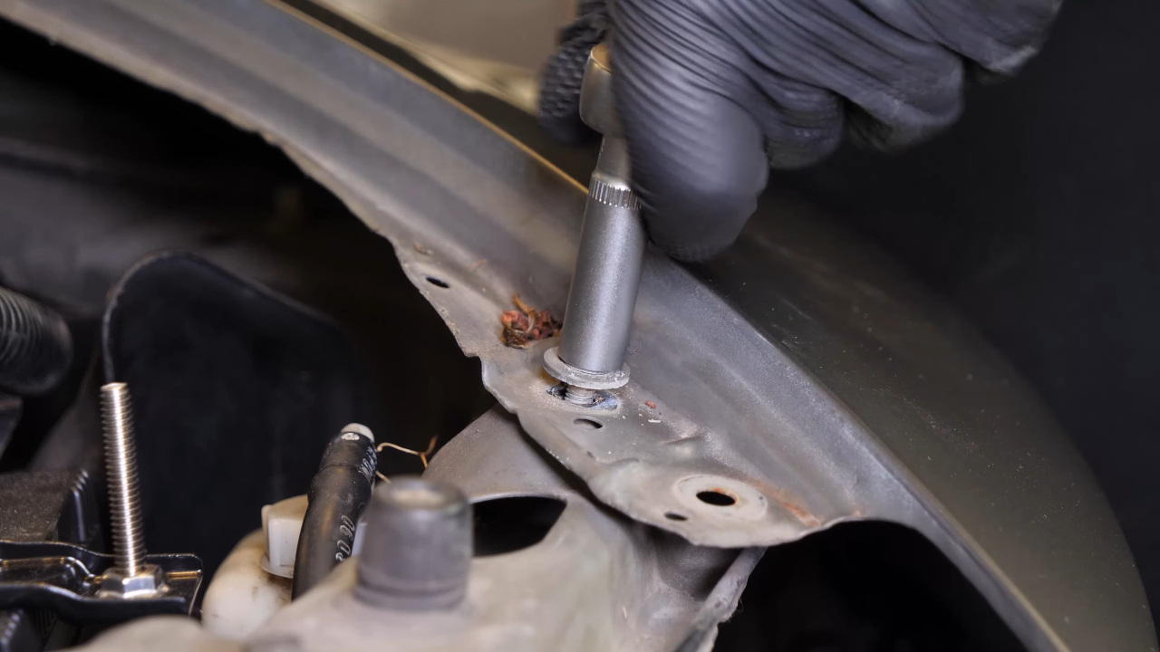 Remove the bolts along the hood