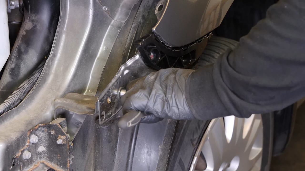 Remove the bolts along the hood