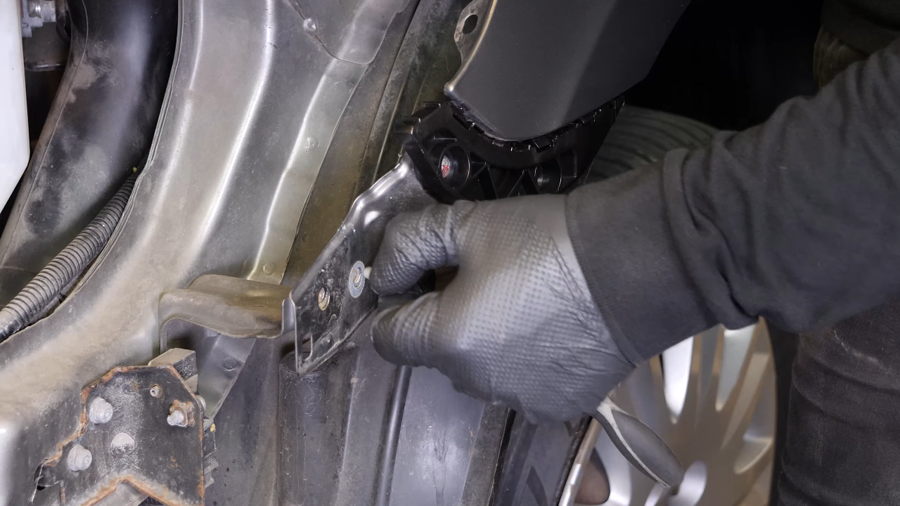 Remove the bolts along the hood