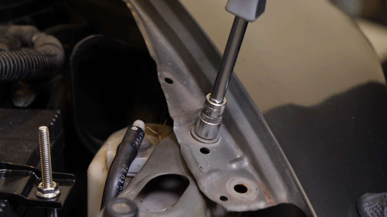 Screw back the bolts along the hood