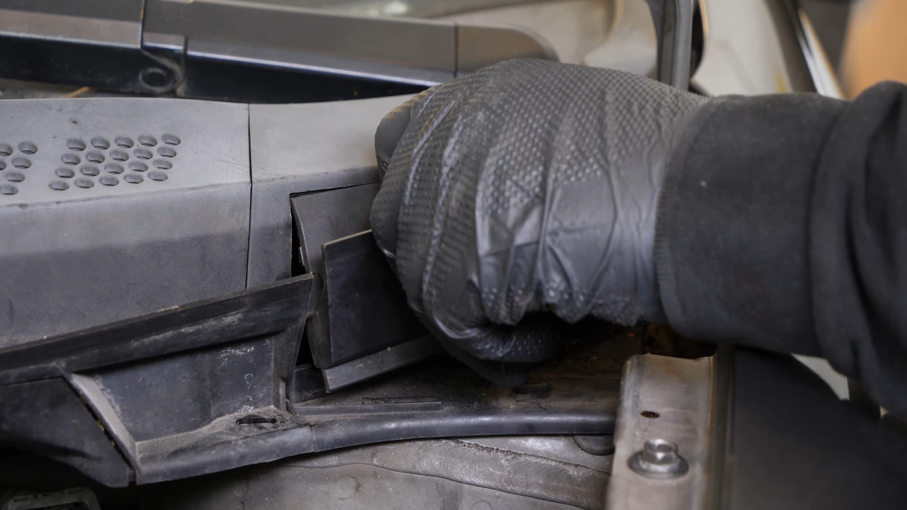 Screw back the bolts along the hood