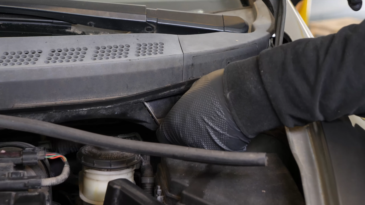 Screw back the bolts along the hood