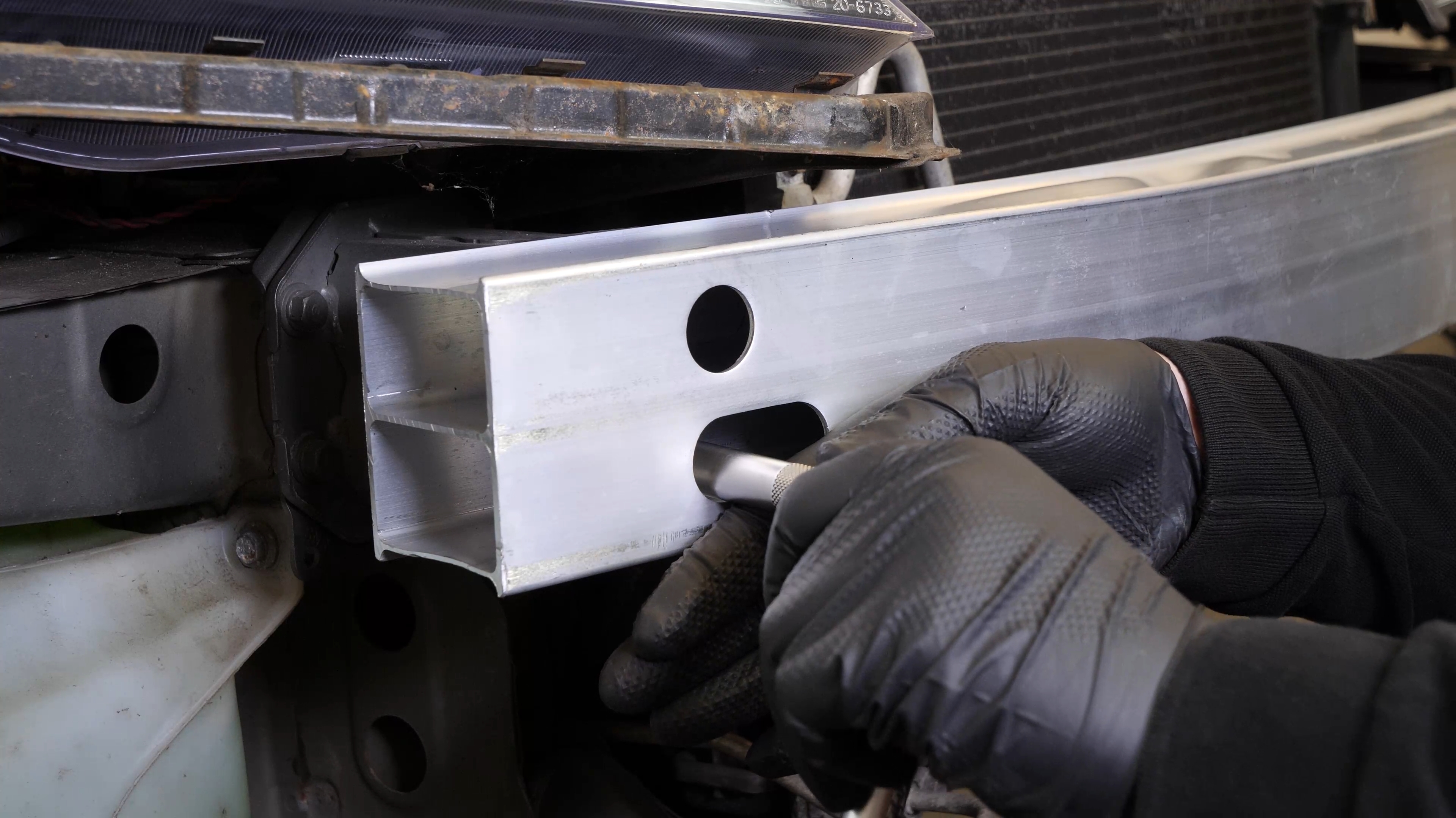 Put the front bumper reinforcement back