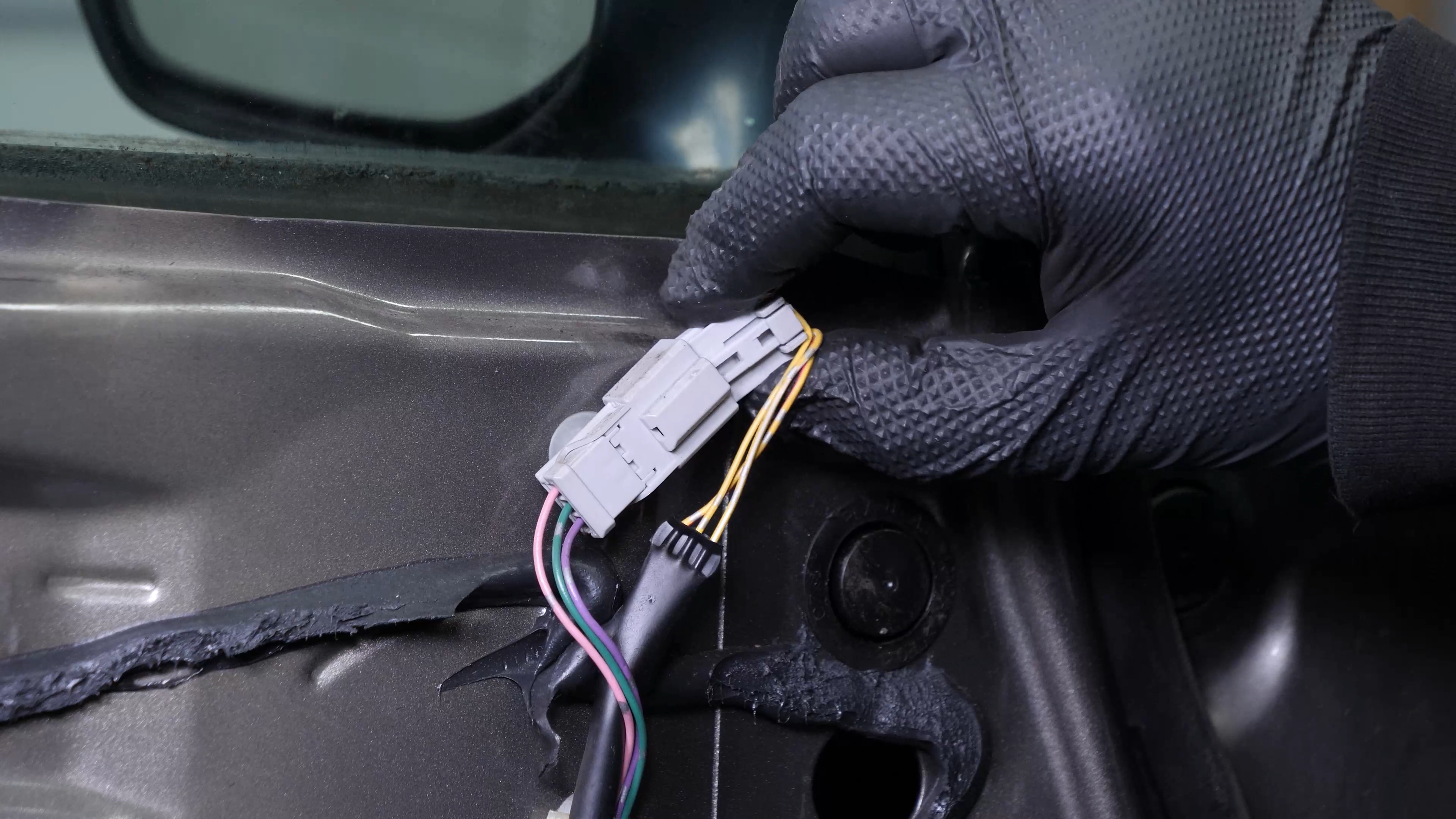 Disconnect the side view mirror connector