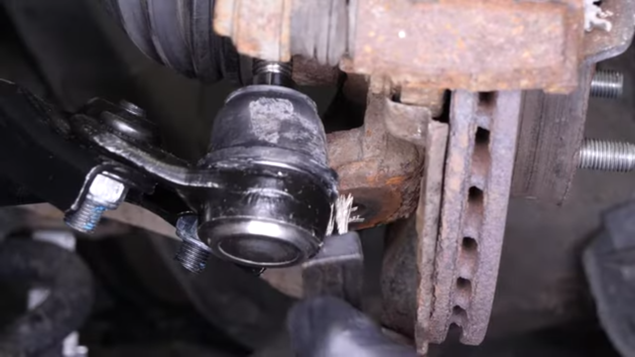 Put the control arm ball joint back