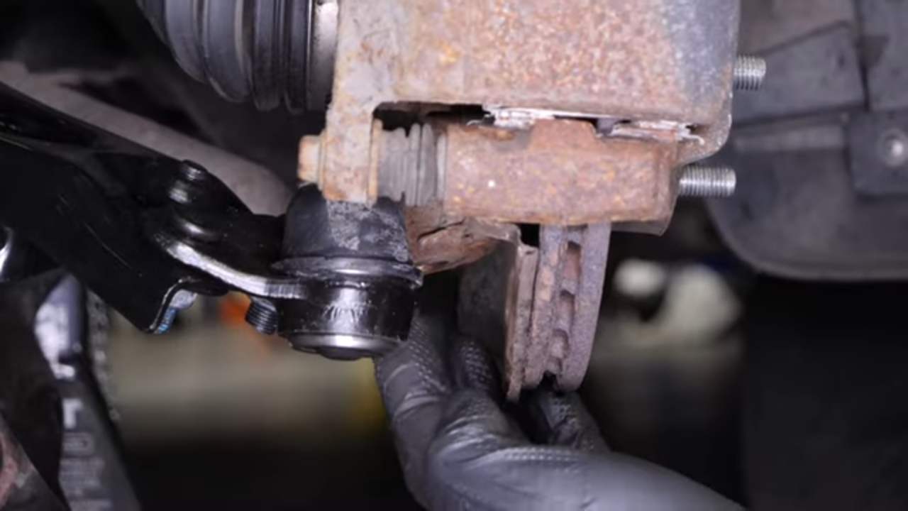 Put the control arm ball joint back