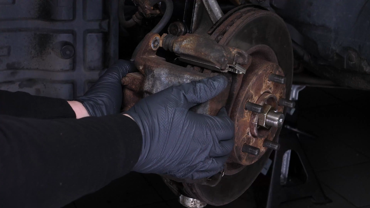 Hang the brake caliper on the strut