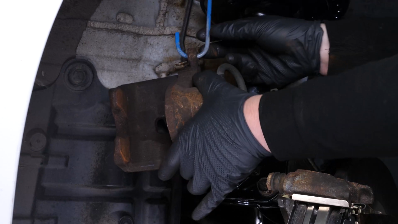 Put the brake caliper back
