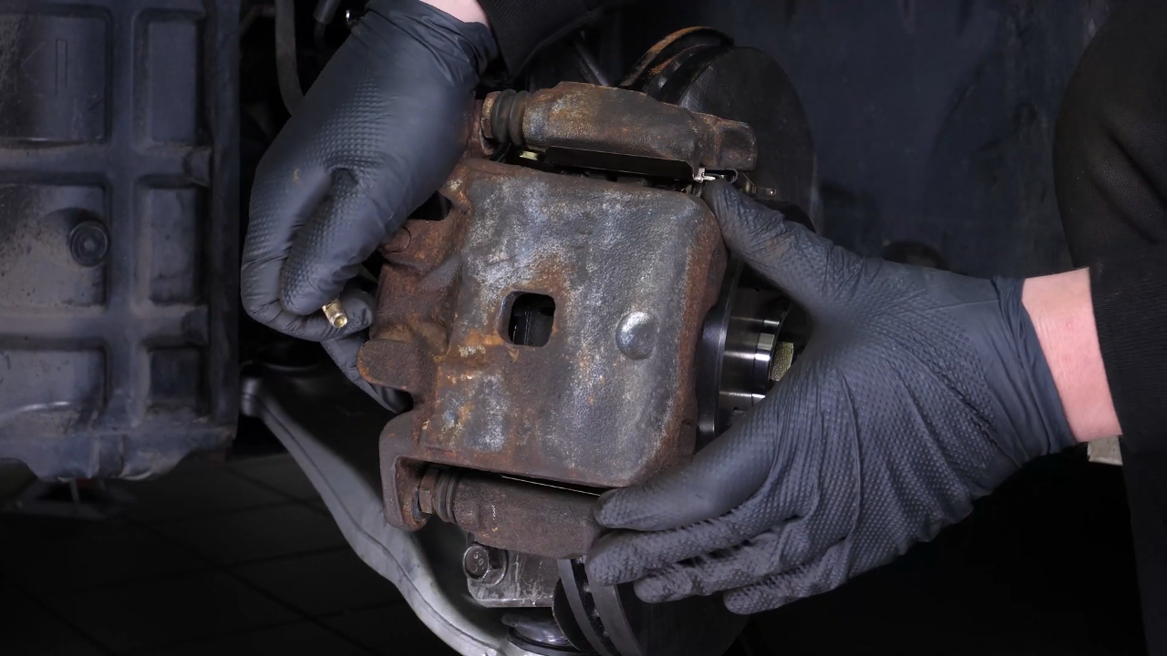 Put the brake caliper back