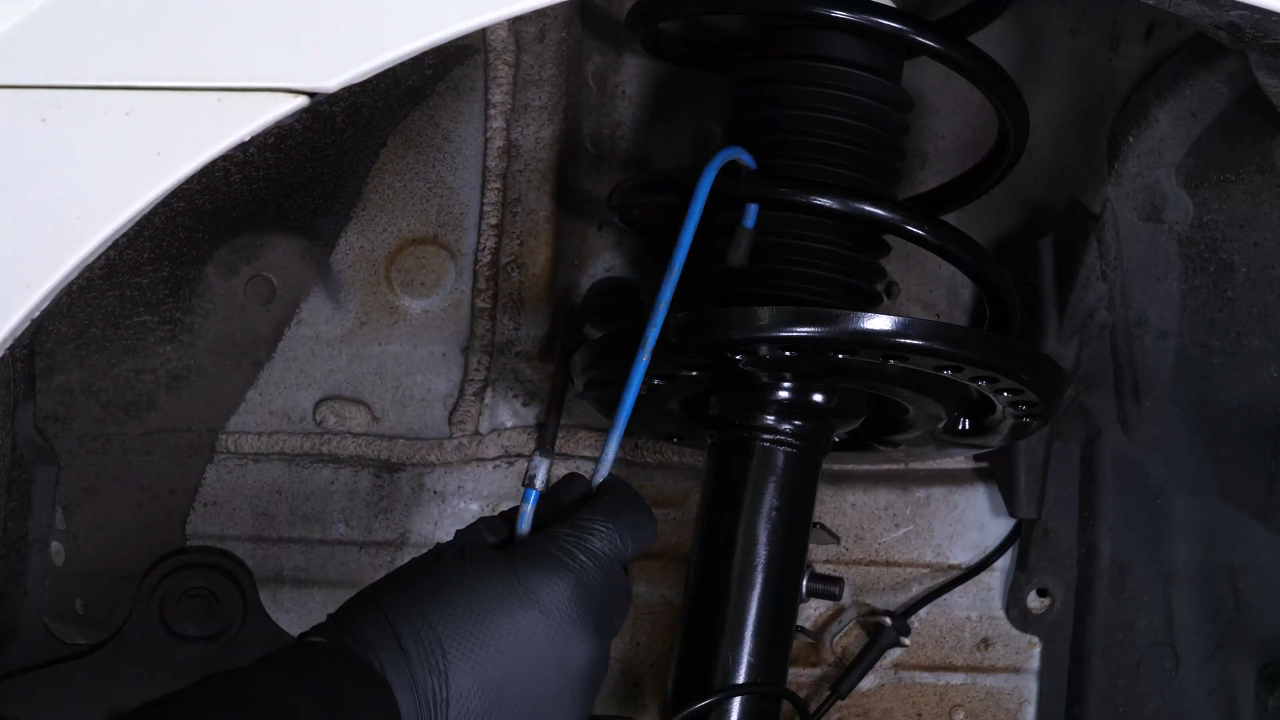 Hang the brake caliper on the strut