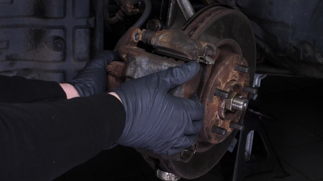 Hang the brake caliper on the strut