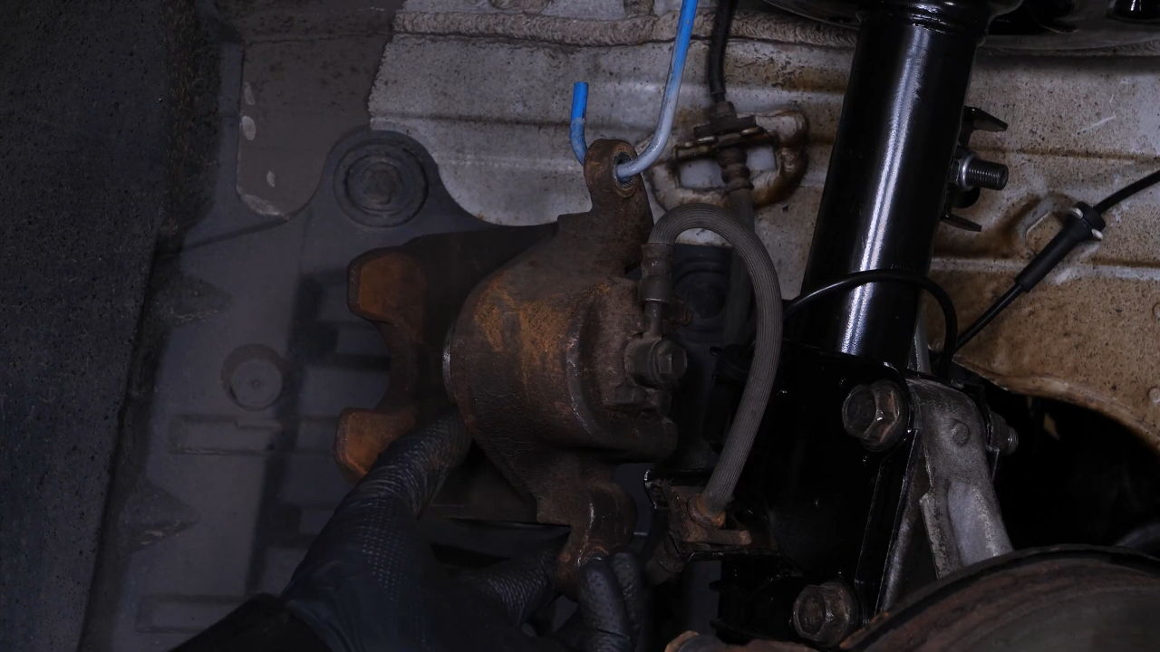 Hang the brake caliper on the strut
