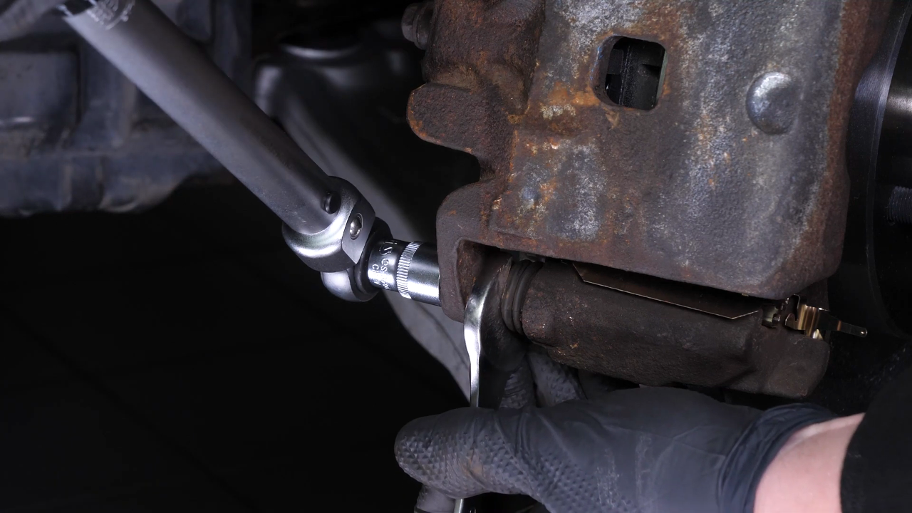 Put the brake caliper back