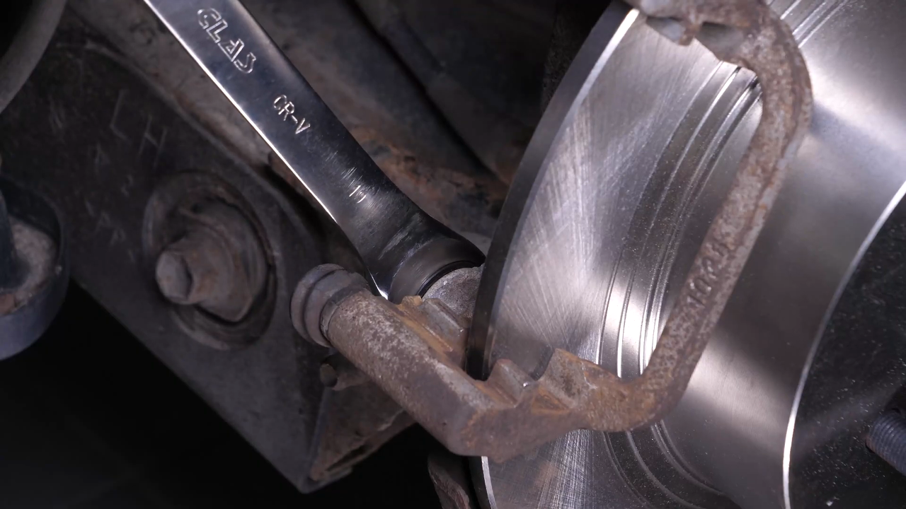 Put the brake caliper mount back on