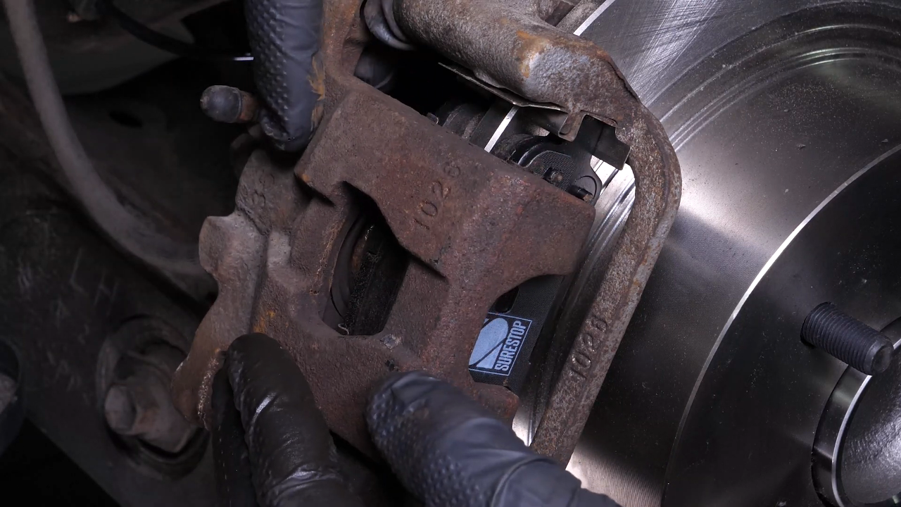 Put the brake caliper back