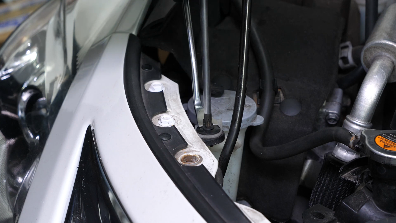Remove the bumper cover / plastic bracket holding screws