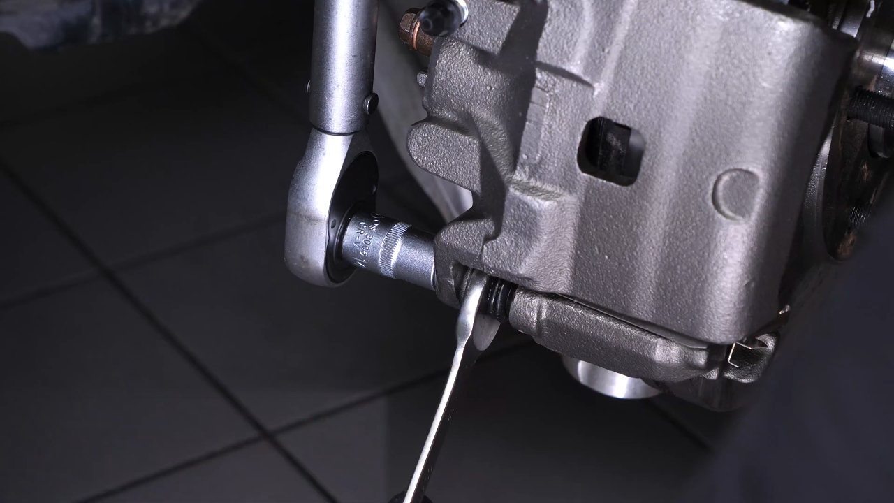 Put the new brake caliper back