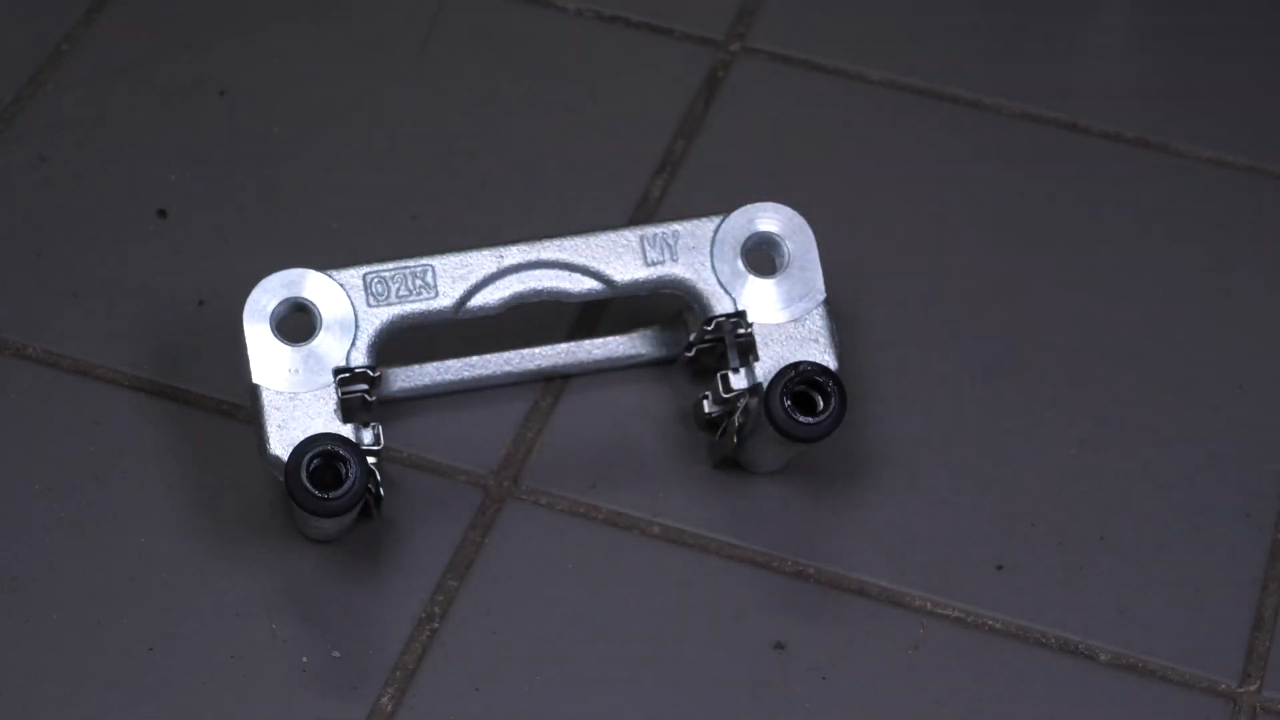 Put the brake caliper mount back on
