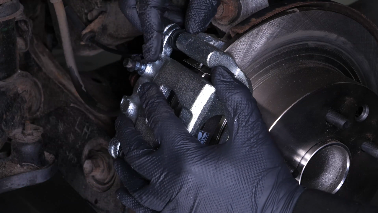 Put the brake caliper back
