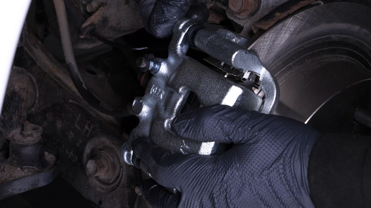 Put the brake caliper back