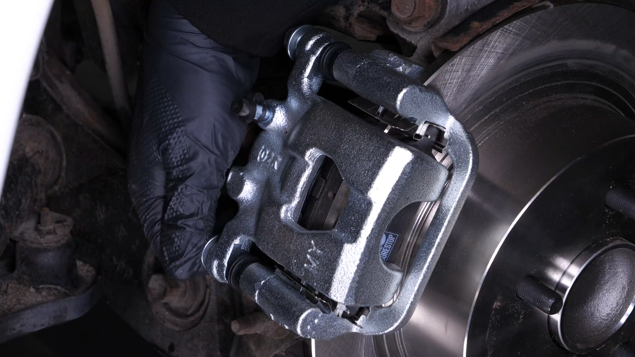 Put the brake caliper back