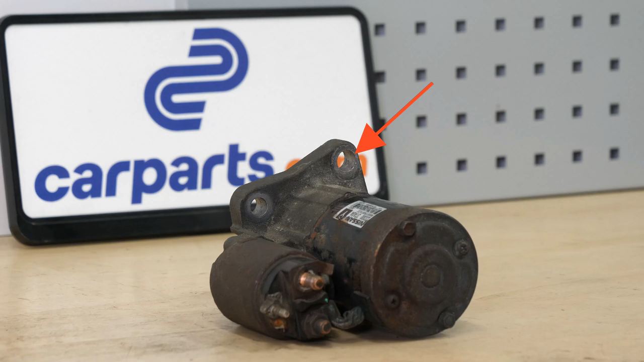 Remove the bolts holding the starter