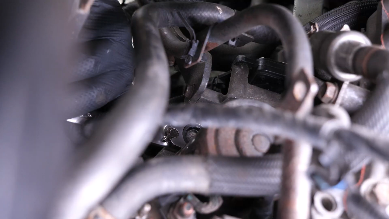 Remove the bolts holding the starter