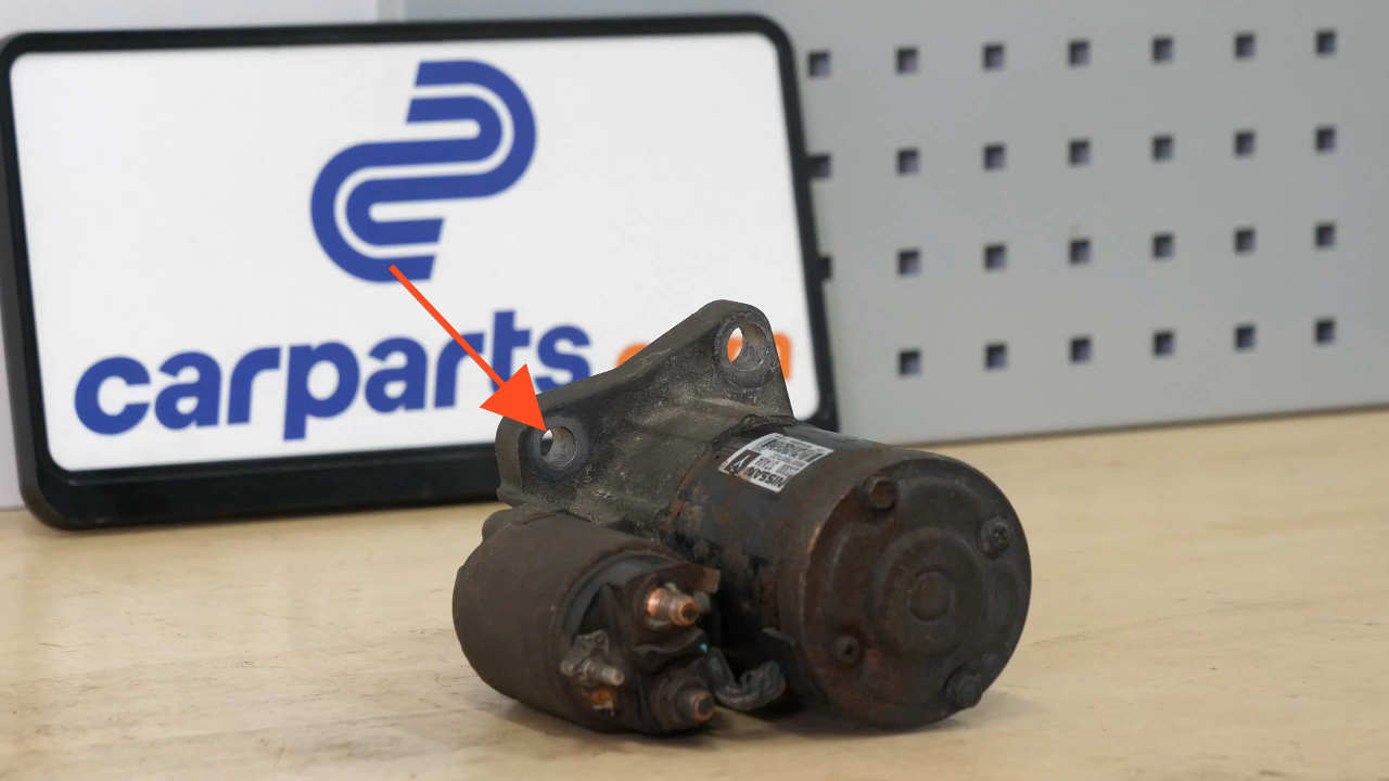 Remove the bolts holding the starter