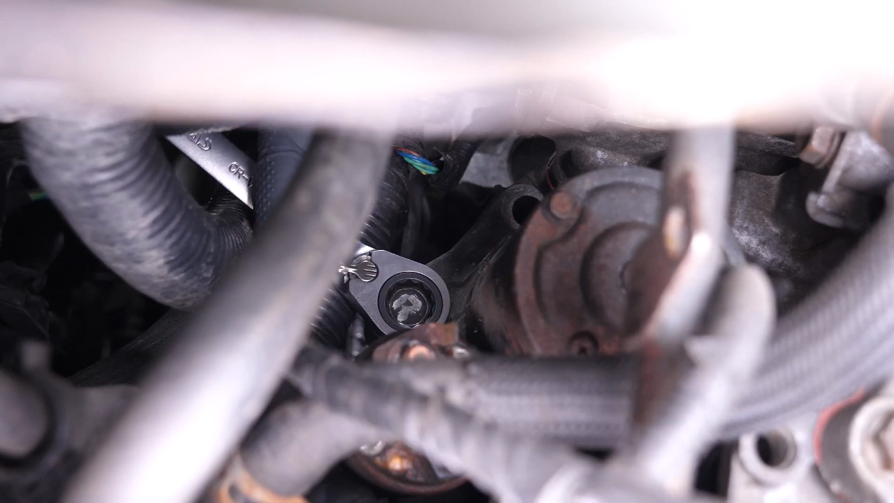 Remove the bolts holding the starter