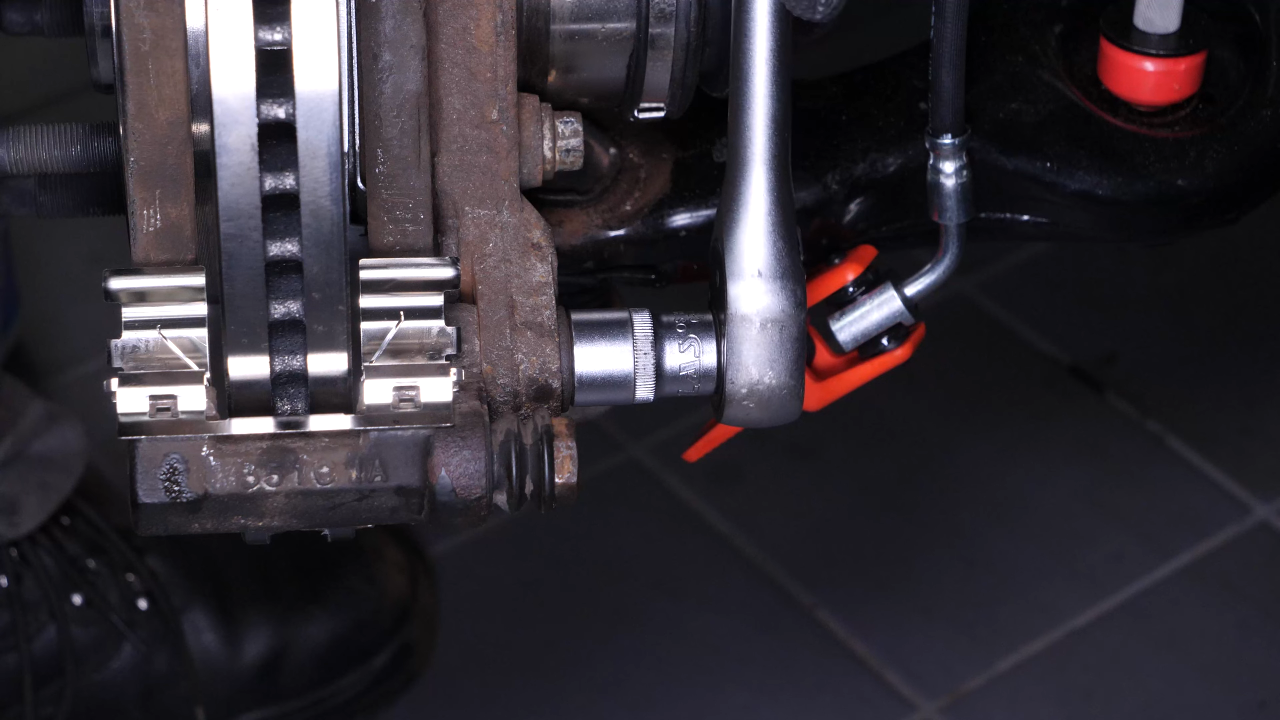 Remove the brake caliper mount