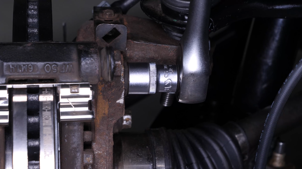 Remove the brake caliper mount