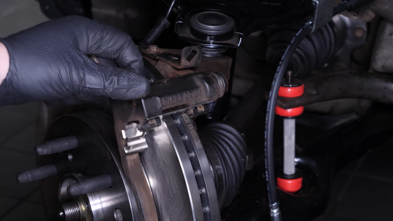 Remove the brake caliper mount