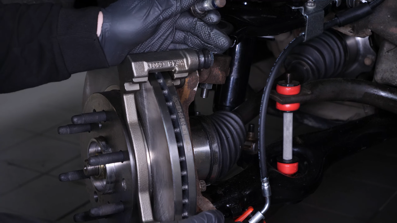 Put the brake caliper mount back on