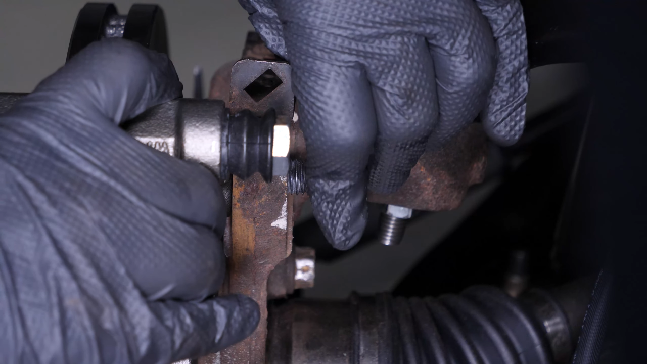 Put the brake caliper mount back on