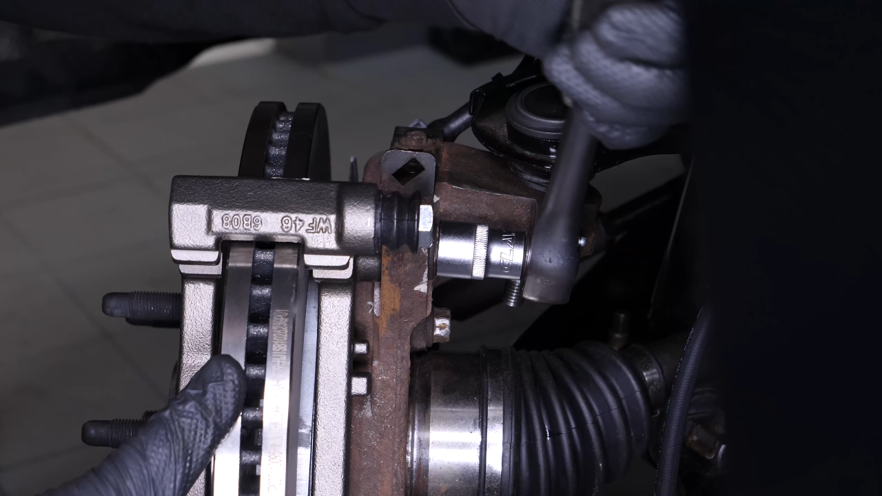 Put the brake caliper mount back on