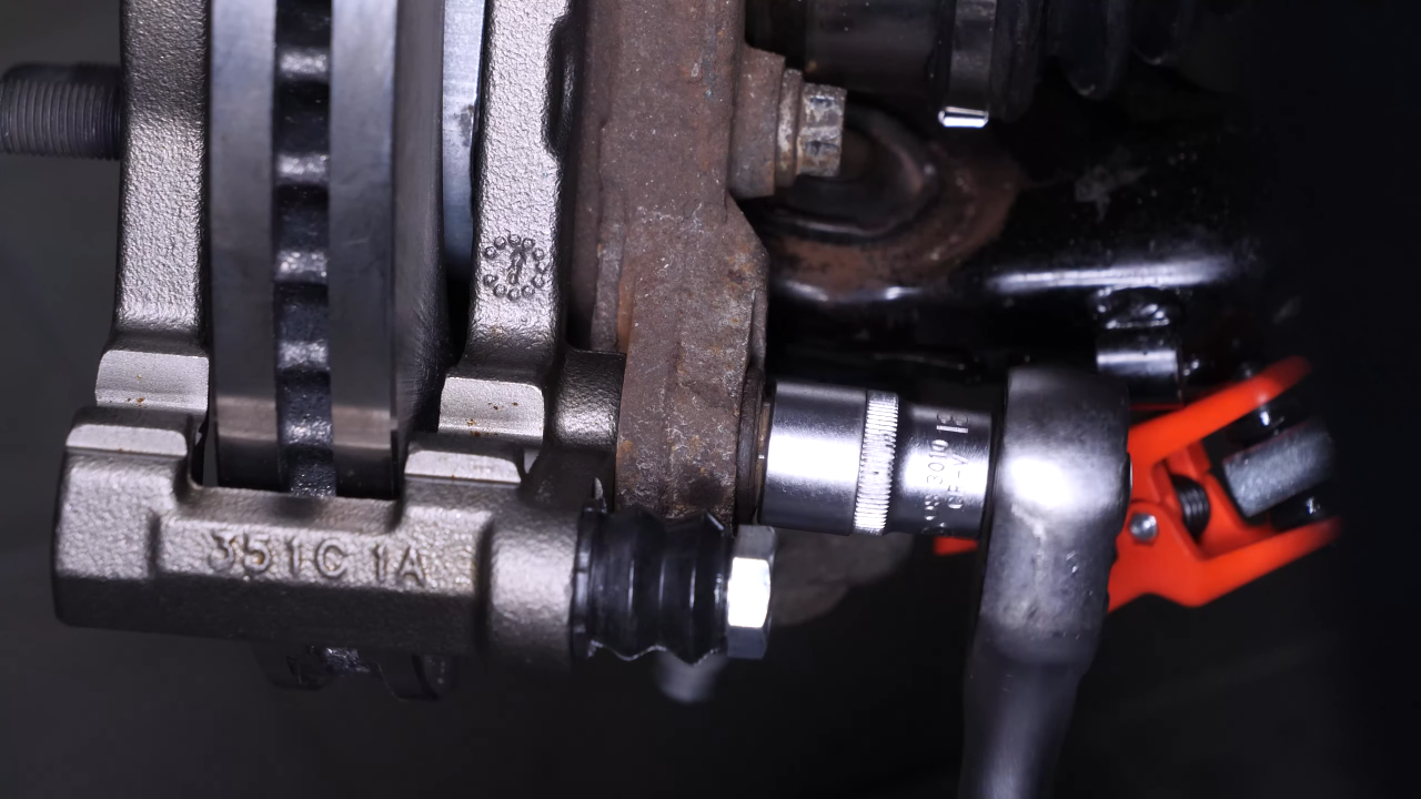Put the brake caliper mount back on