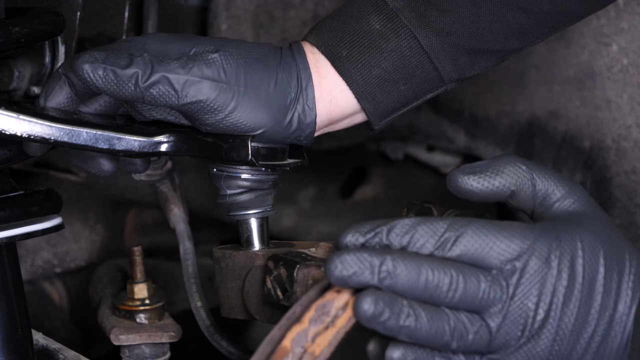 Put the control arm ball joint back