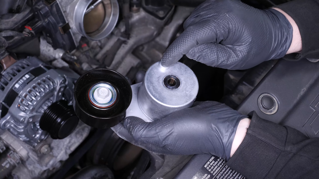 Put the belt tensioner back