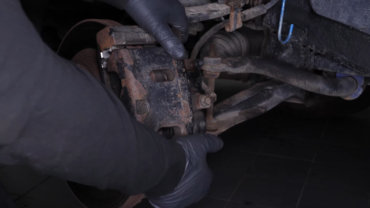 Hang the brake caliper on the strut